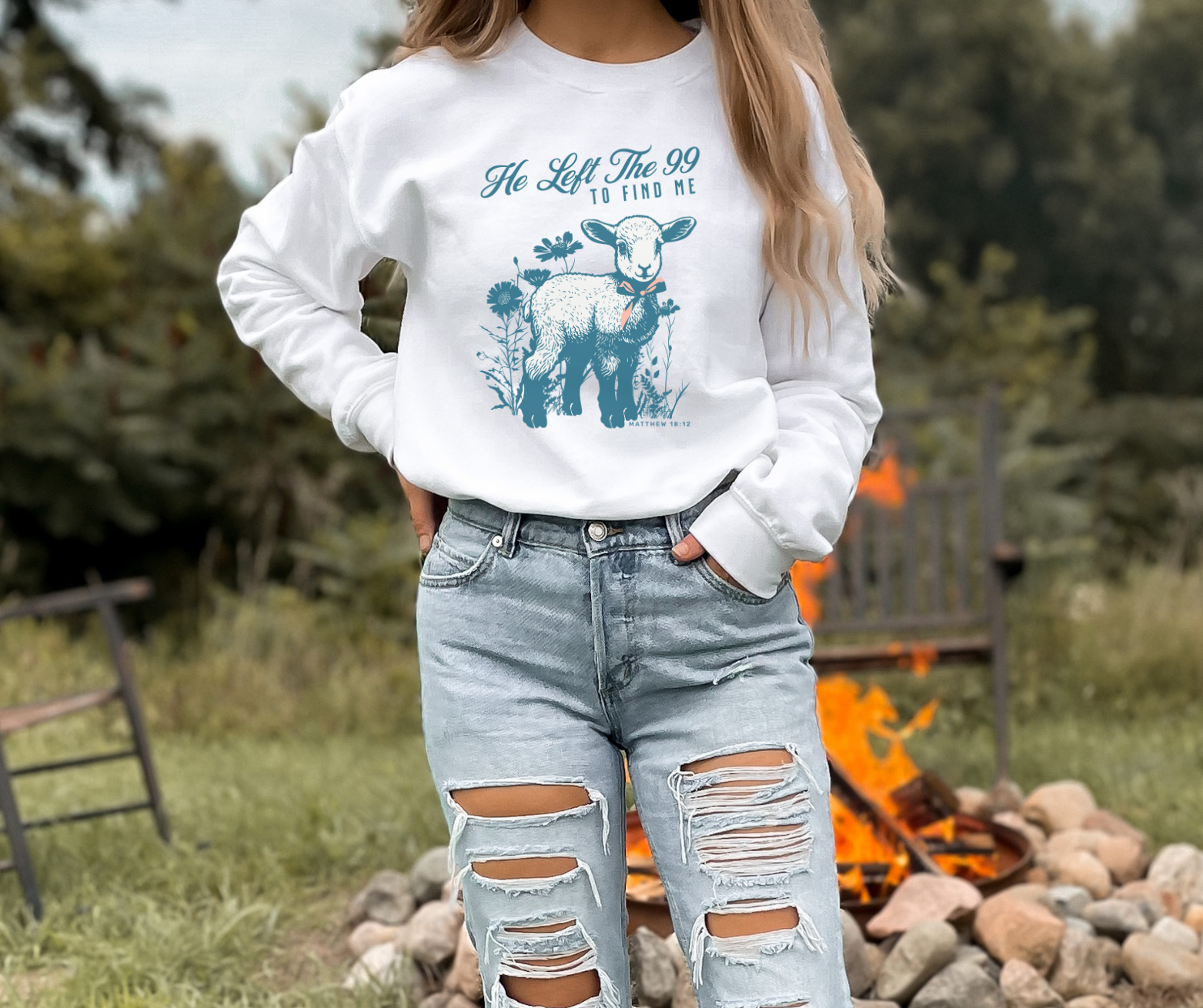 woman wearing a he left the 99 to find me religious sweatshirt