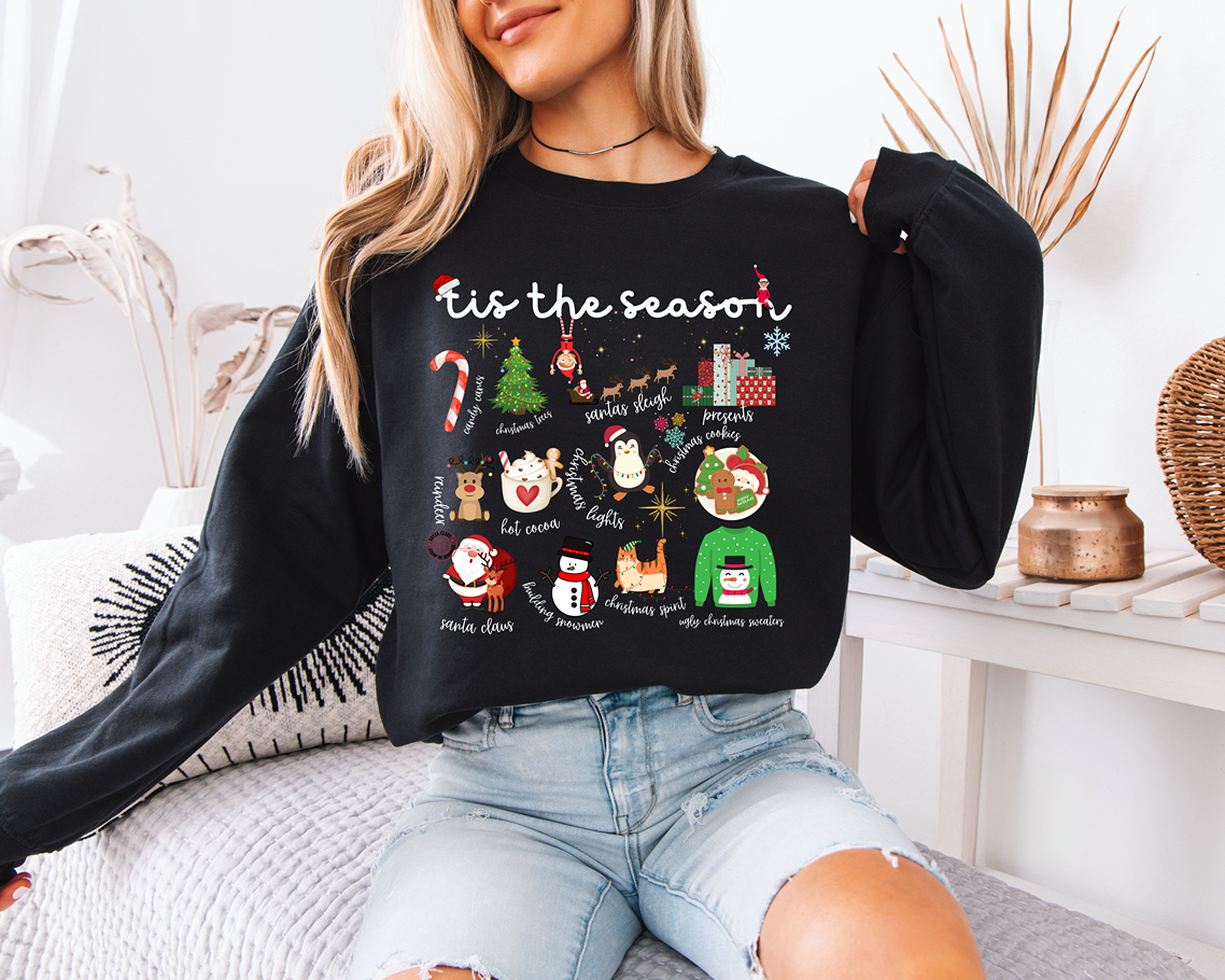 woman wearing a black tis the season christmas sweatshirt

