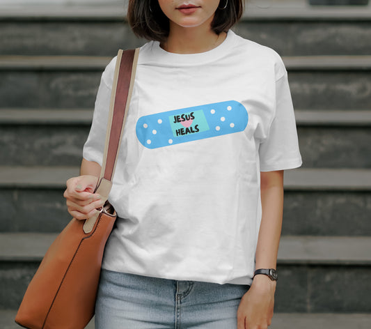 woman wearing a jesus heals band aid tshirt