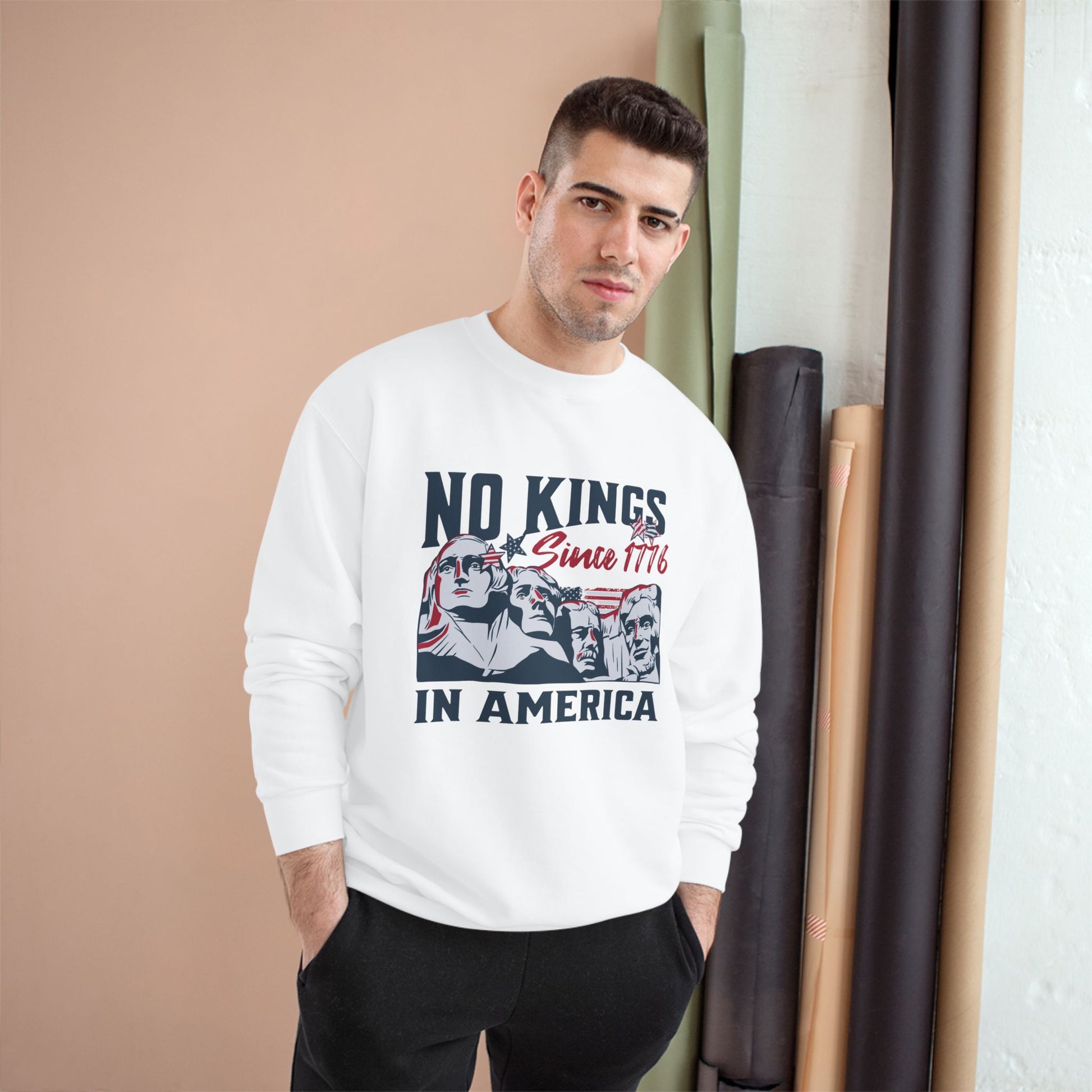 Man wearing white champion s600 No Kings In America Graphic Sweatshirt