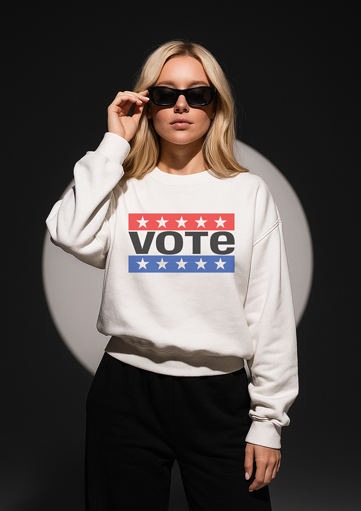 person wearing a white sweatshirt that says VOTE