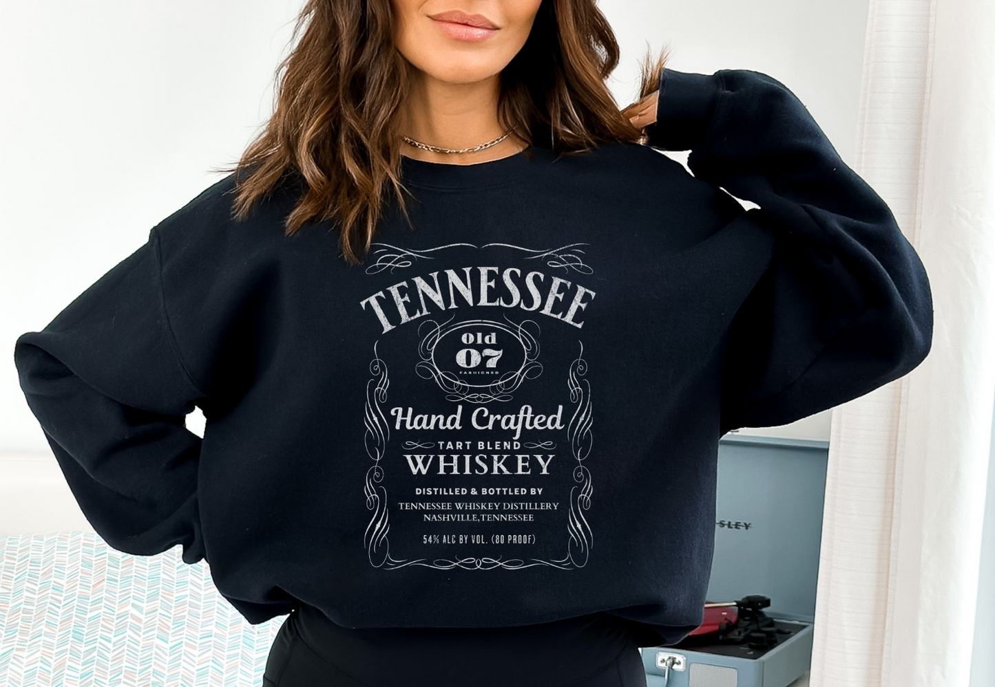 woman wearing a black tennessee whiskey graphic sweatshirt