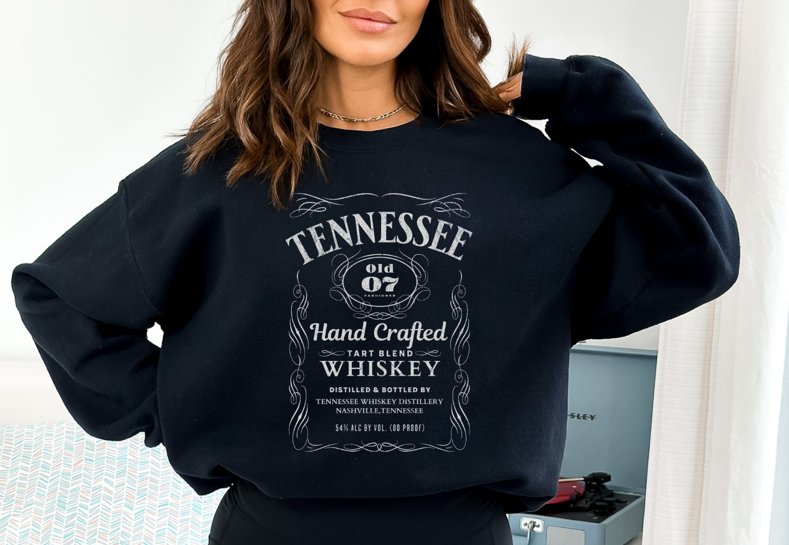woman wearing a black tennessee whiskey graphic sweatshirt