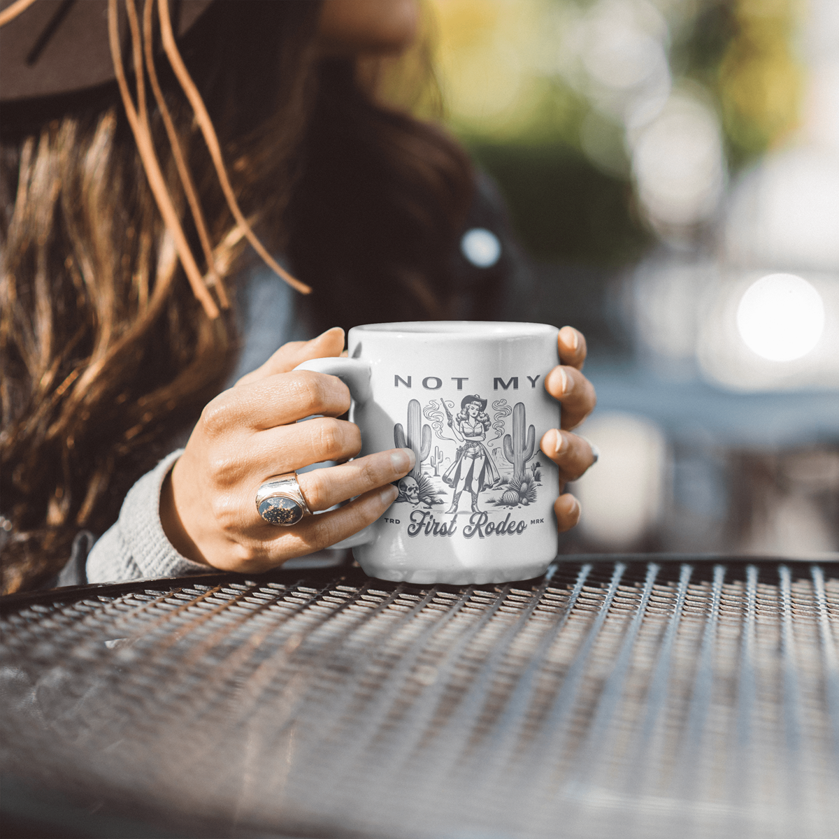 woman holding a 11oz white ceramic mug that says not my first rodeo